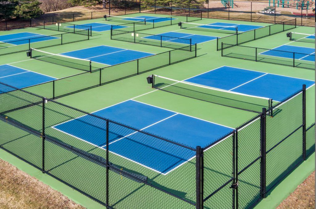 How To Paint Lines On a Pickleball Court. This image shows multiple courts with an aerial view of the lines.