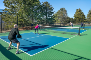 People playing doubles pickleball.